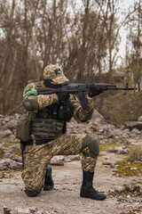 Ukrainian soldier of the Armed Forces of Ukraine sits taking aim