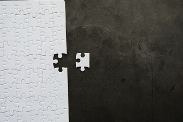 Intellectual puzzles. The puzzle is empty. The hand puts together puzzle pieces. Brain training.