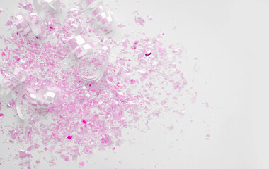 Pink Metallic Confetti and Paper Swilrls on a White Background.Simple Modern Composition with...