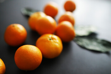 Citrus fruits on a gray background. Tangerines with leaves. Christmas fruit.