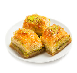 baklava with pistachios, 3 pieces, on a white plate, isolated, side view, close-up