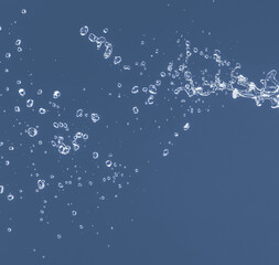 Water splash on a blue background. Reflection on the surface of the water.