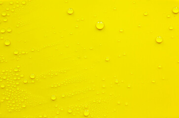 Water drops on a yellow background.