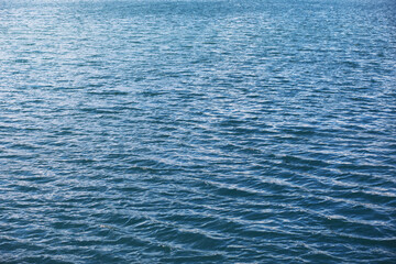 Obraz premium Water surface. The texture of the water. Waves on the lake in windy weather.