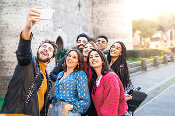 Group of milenials best friends having fun shooting smartphone selfies moments - Young people hangout in the street and having fun taking pictures - youth lifestyle concept