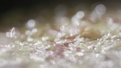 Close up tracking shot of chopped onion being sauteed in hot sizzling butter in skillet