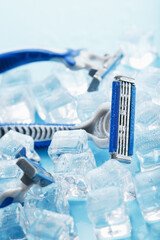 Three shaving machines on a frosty blue background with ice. The concept of cleanliness and frosty freshness