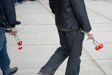 A carnation in the hands of a man. Flowers in the hands of a man.