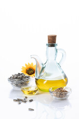 Sunflower oil and sunflower seeds isolated on white background with copyspace. Vertical format.