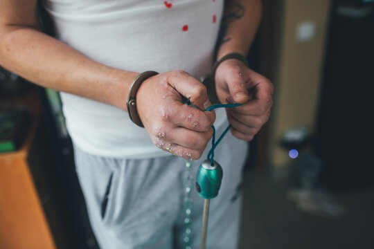 The concept of a scary image for Halloween. Concept for mental illness. Makeup concept for scary scenes. Handcuffs on hands. The concept of arresting an offender.