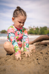 little child playing on the beach