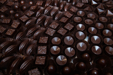 Lots of handmade chocolate candies with filling in a chocolate factory