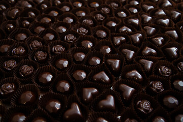 Lots of handmade chocolate candies with filling in a chocolate factory