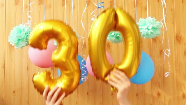 Happy thirtieth birthday with golden number thirty 30 air balloons and colorful decorations