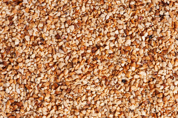 Ground peanuts or chestnuts background. Copy space.
