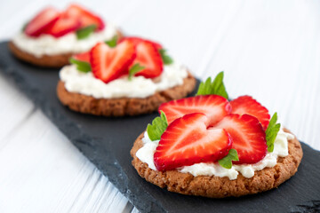Healthy toast with strawberry, cream cheese and mint leaf. Tasty breakfast. Clean eating, dieting...