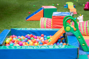 Pool of balls and games for a children's party in the garden of a house, for birthdays