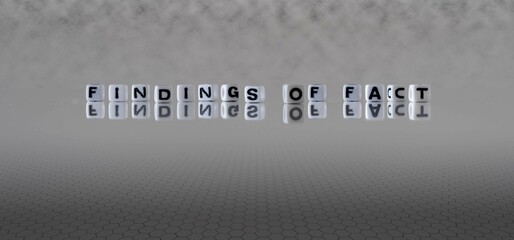 findings of fact word or concept represented by black and white letter cubes on a grey horizon background stretching to infinity