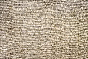 Background, texture of beige fabric, woven burlap close-up.