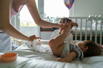 Small caucasian boy four years old watching his baby brother or sister while unknown woman mother...