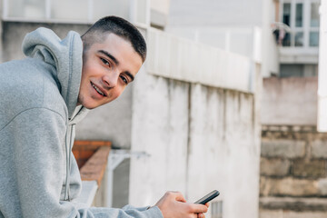 teenage boy on the street with mobile phone