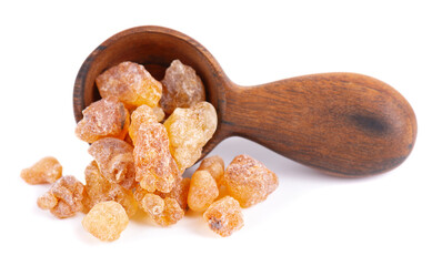 Frankincense resin in wooden spoon, isolated on white background. Pile of natural frankincense...