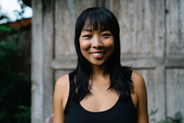 Fototapeta premium Portrait of smiling asian girl looking at camera