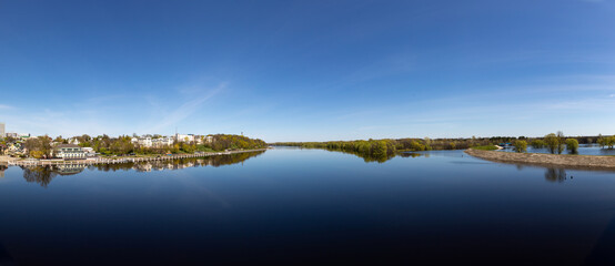 Obraz premium Landscape with river flooding, forest and embankment in the city in spring. Rivers of Belarus. the city of Gomel. Europe.