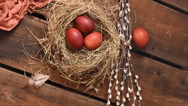 Naturally colored onion husks are Easter eggs in a nest of hay and willow branches. Traditions Orthodoxy religion. High quality 4k footage