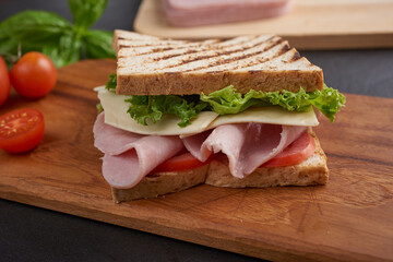 Sandwich with ham and cheese. Grilled and pressed toast with smoked ham, cheese, tomato and lettuce...