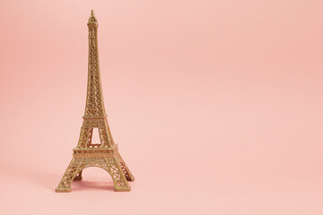 Fototapeta na wymiar golden effiel tower souvenir with pink background