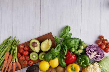 Healthy food background. Food photography different fruits and vegetables on white wooden table background. Copy space. Shopping food in supermarket. studio photo of different fruits and vegetables.