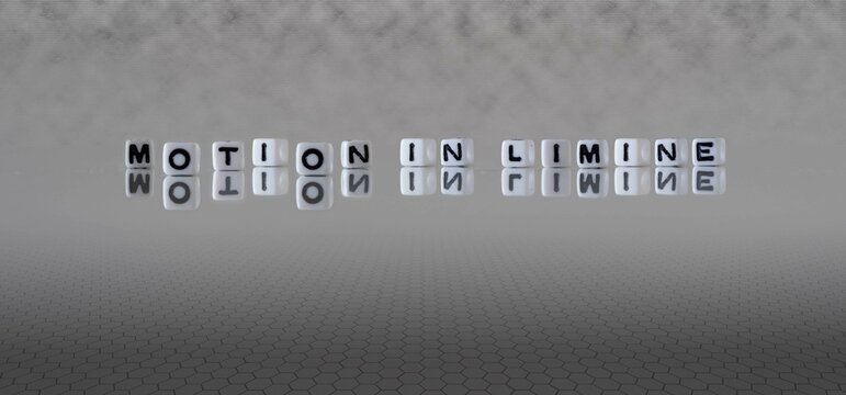 motion in limine word or concept represented by black and white letter cubes on a grey horizon background stretching to infinity
