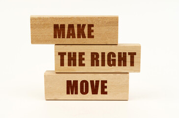 On a white surface are wooden blocks with the inscription - MAKE THE RIGHT MOVE