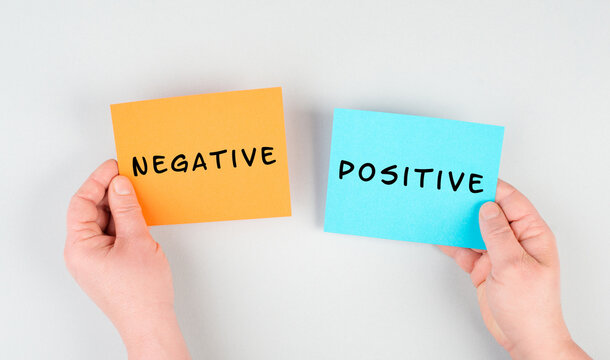 The words negative and positive are standing on paper, business and service rating, evaluation concept, marketing, having an optimistic mindset