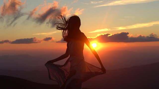Woman silhouette enjoying nature sunset. Girl silhouette jumping and enjoying life. Silhouette of woman run and jump at sunset. Success life.