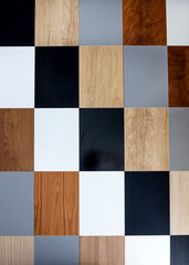 Room design. Wall with abstract multicolored geometric pieces of wood of rectangular size.