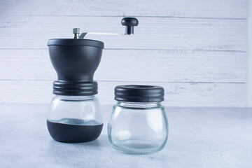 Machine to make coffee, with integrated grinder and containers on a gray background