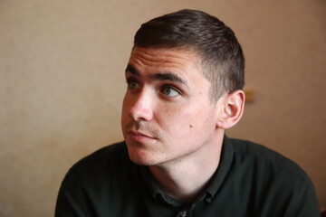 Fototapeta premium Defocus charming thoughtful, charismatic man trying think up solution. Creative handsome brunet boyfriend grey eyes raising eyebrows looking at upper left corner, thinking. Out of focus