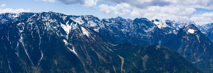 snow covered mountains blue sky and clouds
