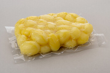 Potatoes in vacuum packed sealed for sous vide cooking isolated on Gray background