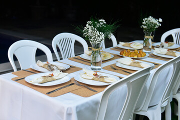 table set for a dinner, ornamental flowers, birthday party, dinner table setting, dining table, simple table, simple dinner