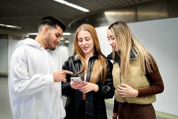 Mixed group of friends looking at the phone