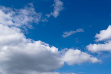 White clouds floating across the blue sky