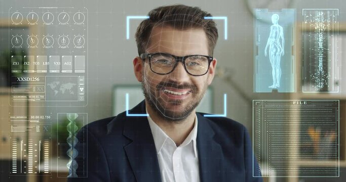 Successful businessman in eyeglasses and stylish suit sitting at bright modern office with square frame on face from innovative recognition system. Concept of innovative security program.