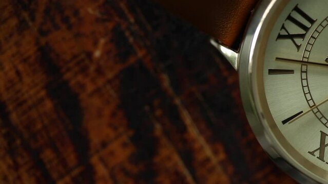 Vintage background for copy space. macro watch. Extreme closeup of gold metallic second arrow passing by on  clock face.