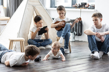 Five kids at home in the living room playing games