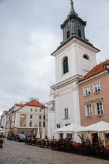 Obraz premium Warsaw, Poland, 13 October 2021: St. Hyacinth's Church with bell tower in New town, founded by Dominican Order and adjoins largest monastery, Renaissance and early-Baroque styles at sunny day