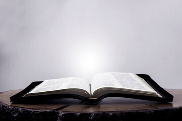 Open Bible. Holy Scripture. Light from a book. Gospel