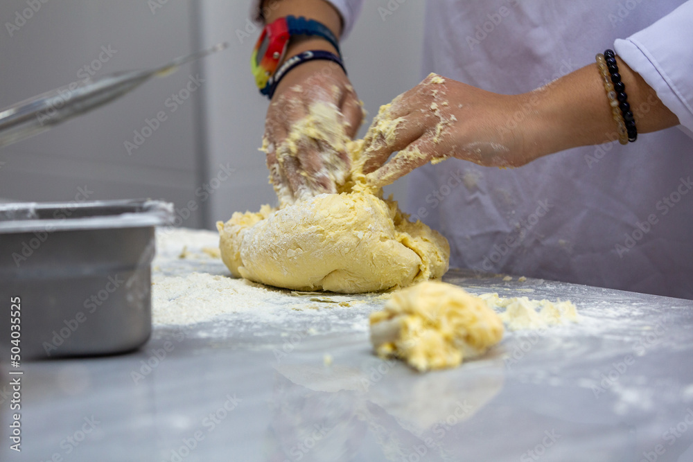 Poster A cook kneading dough for pies. BLURRY BLURRY BLURRY